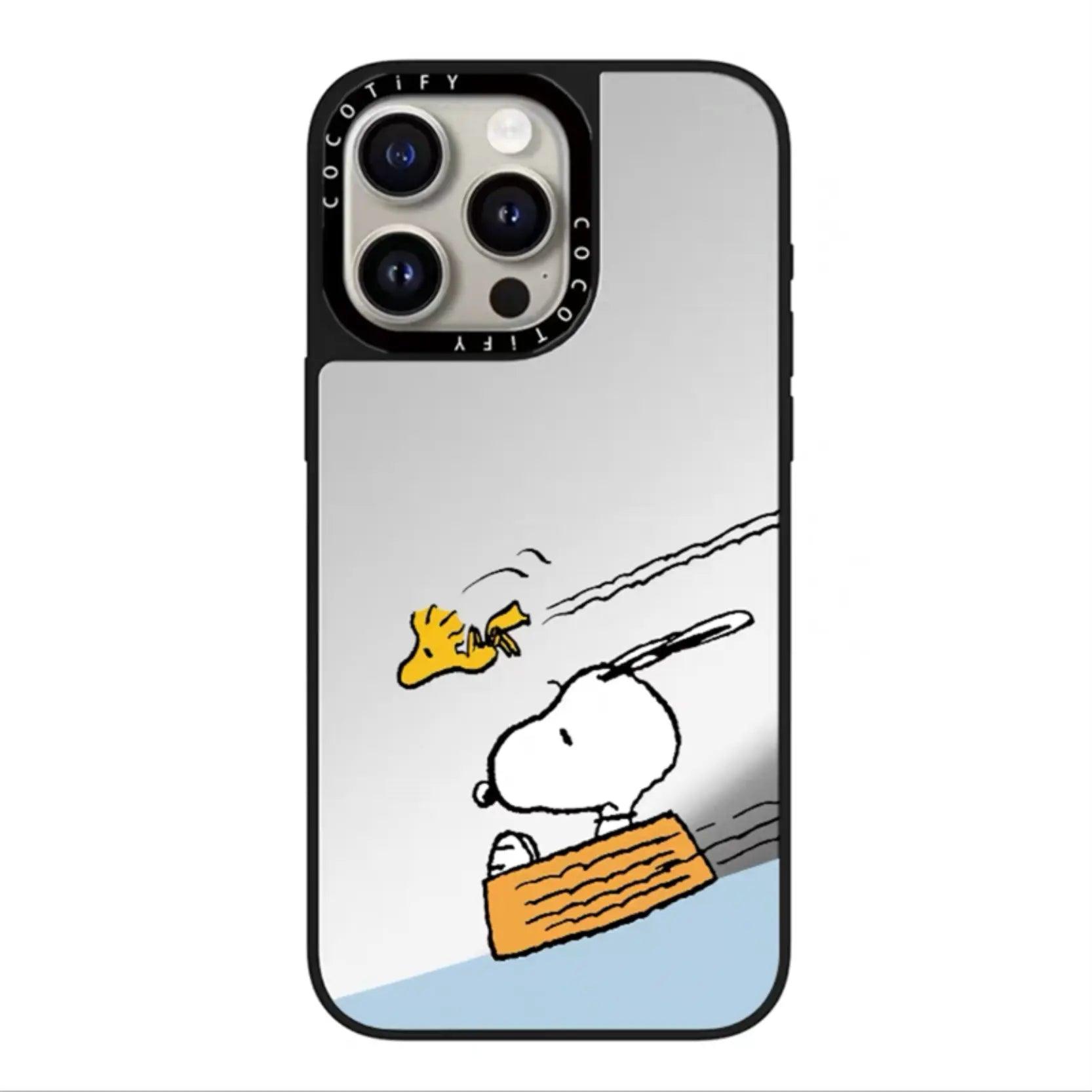 Snoopy surfing phone case shows the white beagle lying on an orange surfboard in a dynamic descent. Woodstock flies above leaving V-shaped trails against a light gray sky and blue water background.